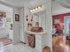 Bright bathroom featuring a vanity area, white cabinetry and a decorative mirror at 9313 W Arrowhead Dr, Sun City, AZ 85351