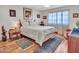 Bedroom showcasing a cozy bed, wood flooring, and natural light at 9313 W Arrowhead Dr, Sun City, AZ 85351