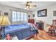 Bedroom showcasing a ceiling fan, wood flooring, and natural light at 9313 W Arrowhead Dr, Sun City, AZ 85351