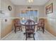 Cozy dining area with wood table, chairs, and bright window with shutter blinds at 9313 W Arrowhead Dr, Sun City, AZ 85351