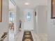 Bright entryway with tiled floor, decorative rug, and front door with glass insert at 9313 W Arrowhead Dr, Sun City, AZ 85351