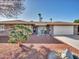 Inviting front of the house with desert landscaping and quaint seating area at 9313 W Arrowhead Dr, Sun City, AZ 85351