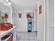 Bright hallway featuring white tile flooring, white walls and colorful decor at 9313 W Arrowhead Dr, Sun City, AZ 85351