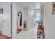 Bright hallway featuring white tile flooring, white walls and decorative furniture at 9313 W Arrowhead Dr, Sun City, AZ 85351