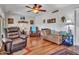 Bright living room featuring hardwood floors, comfortable seating, and modern decor for relaxing and entertaining guests at 9313 W Arrowhead Dr, Sun City, AZ 85351