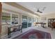 Bright sunroom with ample natural light, offering versatile space with cozy seating and a work area at 10602 W Roundelay Cir, Sun City, AZ 85351