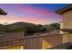 Balcony overlooking the neighborhood with mountain views, lush landscaping, and a beautiful sunset sky at 10829 N 11Th Pl, Phoenix, AZ 85020