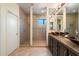 Bathroom features a large walk-in shower with frameless glass doors and a granite countertop vanity with dual vessel sinks at 10829 N 11Th Pl, Phoenix, AZ 85020