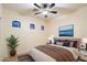 Well-lit bedroom with arched windows, a ceiling fan, and tasteful decorations at 10829 N 11Th Pl, Phoenix, AZ 85020