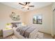 Stylishly decorated bedroom with a bed, modern nightstands, decorative shelves, and a window providing natural light at 10829 N 11Th Pl, Phoenix, AZ 85020