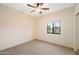Cozy bedroom featuring neutral walls, a ceiling fan, carpet flooring, and a window with natural light at 10829 N 11Th Pl, Phoenix, AZ 85020