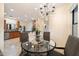 View of a dining area and kitchen featuring tile floors, a chandelier, and an island with a counter at 10829 N 11Th Pl, Phoenix, AZ 85020