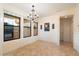Bright dining area featuring tile flooring, a chandelier, and large windows at 10829 N 11Th Pl, Phoenix, AZ 85020