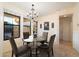 Elegant dining room featuring a chandelier, a glass table, and views of the outside at 10829 N 11Th Pl, Phoenix, AZ 85020