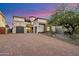 Beautiful stucco home with a large brick driveway and two car garage, surrounded by mature landscaping at 10829 N 11Th Pl, Phoenix, AZ 85020