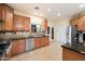 A well-lit kitchen with stainless steel appliances, wooden cabinets, and granite countertops at 10829 N 11Th Pl, Phoenix, AZ 85020