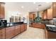 Spacious kitchen featuring modern appliances, wooden cabinetry and black granite countertops at 10829 N 11Th Pl, Phoenix, AZ 85020