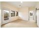 Bright living room showcasing neutral walls, large windows, and a door to the balcony at 10829 N 11Th Pl, Phoenix, AZ 85020