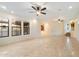 Open-concept living room with tile floors, ceiling fans and a view of the staircase at 10829 N 11Th Pl, Phoenix, AZ 85020