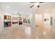 Large living room with tiled floors, ceiling fans, and light beige paint at 10829 N 11Th Pl, Phoenix, AZ 85020