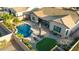 Expansive aerial view of the backyard, including a refreshing pool, patio, and well-manicured lawn at 10906 E Thornton E Ave, Mesa, AZ 85212