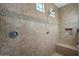 Walk-in shower featuring contemporary tile and fixtures, along with a convenient bench seat at 10906 E Thornton E Ave, Mesa, AZ 85212