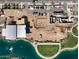 Aerial view of an active construction site, showing the development of new homes and community facilities near a serene lake at 1229 W J Waltz Way, Apache Junction, AZ 85120