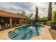 Backyard showcasing the pool and covered patio with dining furniture at 13220 N 99Th Pl, Scottsdale, AZ 85260