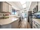 Charming kitchen with modern appliances, spacious countertops, and wood floors under a bright skylight at 14206 W Yosemite Dr, Sun City West, AZ 85375