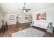 Open-concept living room featuring wood floors, ceiling fan, and a neutral color palette at 14206 W Yosemite Dr, Sun City West, AZ 85375