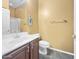 Bathroom features vanity with sink, toilet and tiled flooring with a neutral color palette at 15240 N 142Nd Ave # 2102, Surprise, AZ 85379