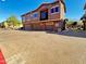 Building exterior features 3 car garages, balconies, desert landscaping, and brick paved parking area at 15240 N 142Nd Ave # 2102, Surprise, AZ 85379