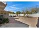 Wide-angle view of a backyard featuring desert landscaping, a wooden deck, and a covered patio for relaxing or entertaining at 1530 E Alameda Dr, Tempe, AZ 85282