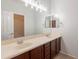 Bright bathroom features double sinks, large mirror, and traditional vanity at 1737 E Azalea Dr, Gilbert, AZ 85298
