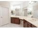 Bathroom featuring double sinks with dark wood cabinets, tile floors, and large mirrors at 1737 E Azalea Dr, Gilbert, AZ 85298