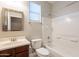 Bathroom featuring a vanity, toilet and shower-tub combo with tiled walls at 1737 E Azalea Dr, Gilbert, AZ 85298