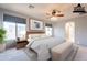 Spacious bedroom with modern furniture, a ceiling fan, and two bright windows at 1737 E Azalea Dr, Gilbert, AZ 85298