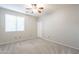 Bedroom with neutral colored walls and carpet with a ceiling fan and blinds at 1737 E Azalea Dr, Gilbert, AZ 85298