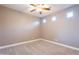 Well lit room with neutral colored walls and carpet, and a ceiling fan at 1737 E Azalea Dr, Gilbert, AZ 85298
