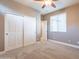 Cozy bedroom with a ceiling fan, a window, and a closet with sliding doors at 1737 E Azalea Dr, Gilbert, AZ 85298