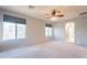 Large primary bedroom features neutral walls, carpet, ceiling fan, and large windows at 1737 E Azalea Dr, Gilbert, AZ 85298