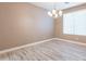 Bright dining room with wood floors and a modern chandelier fixture at 1737 E Azalea Dr, Gilbert, AZ 85298