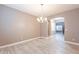 Dining area featuring a chandelier and view to living area with light neutral paint at 1737 E Azalea Dr, Gilbert, AZ 85298