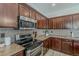 The kitchen has stainless steel appliances, beautiful tile backsplash and granite countertops at 1737 E Azalea Dr, Gilbert, AZ 85298