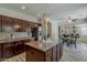 Open kitchen boasts a center island, granite counters, and stainless steel appliances at 1737 E Azalea Dr, Gilbert, AZ 85298