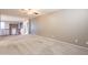 Large living room with carpet, neutral walls, and access to the second story at 1737 E Azalea Dr, Gilbert, AZ 85298