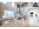 Spacious living room with a two-story ceiling, staircase, and lots of natural light at 1737 E Azalea Dr, Gilbert, AZ 85298