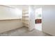 Spacious walk-in closet with gray carpet, custom shelving, and rod; connects to bathroom at 1737 E Azalea Dr, Gilbert, AZ 85298