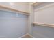 Spacious walk-in closet with shelves, closet rods and ample storage space at 1737 E Azalea Dr, Gilbert, AZ 85298