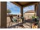 Outdoor patio with seating area, string lights, and desert landscaping at 18644 N Desert Willow Dr, Maricopa, AZ 85138